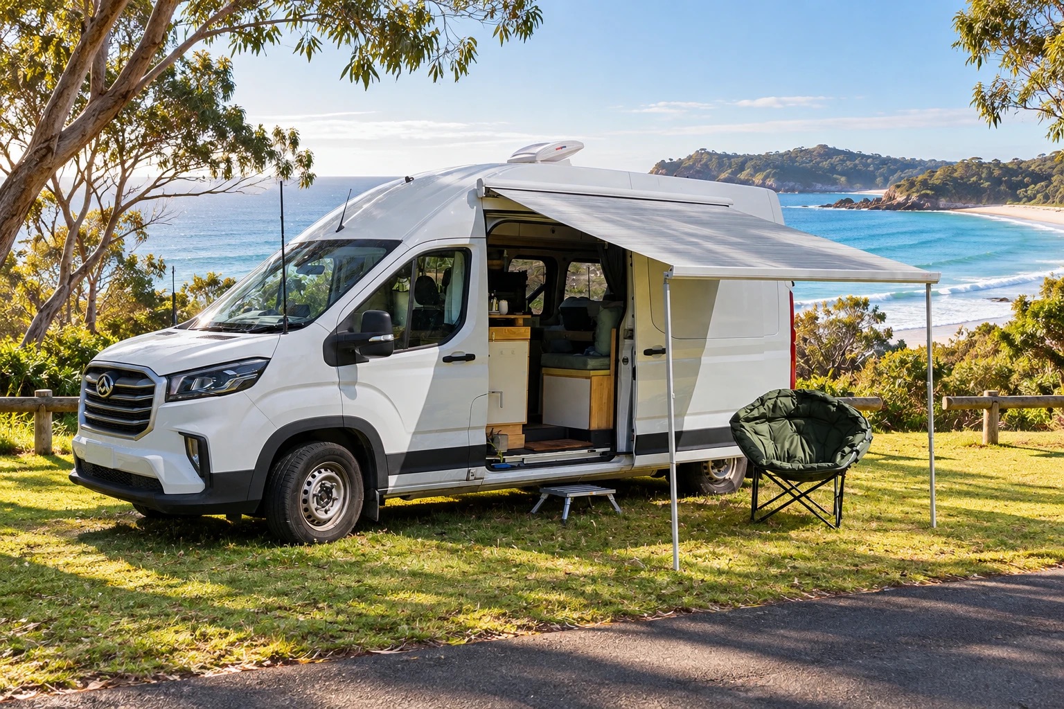 The campervan parked beside a turquoise bay